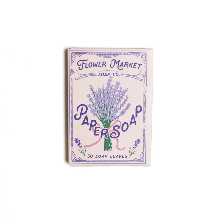 A package of 50 123 Farm Paper Soap leaves with a lavender design, with text indicating the product name and fragrance. 123Farm is available at Luca Essentials in Los Angeles.