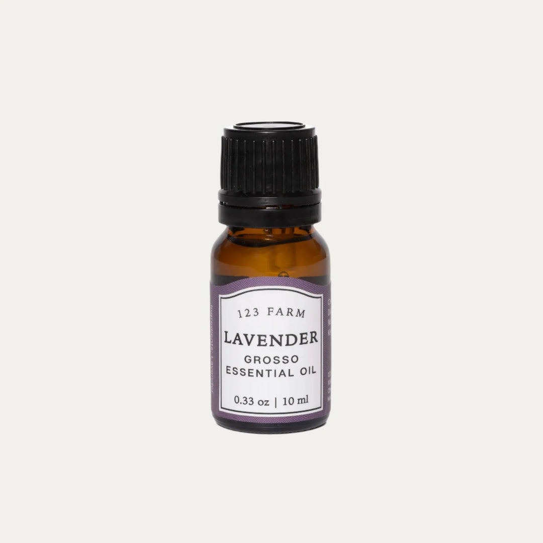 An amber bottle of 123 Farm Lavender Grosso Essential Oil on a white background. 123 Farm is available at Luca Essentials in Los Angeles.