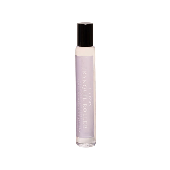A glass roller bottle of 123 Farm Lavender Tranquil Roller is on a white background. 123 Farm is available at Luca Essentials in Los Angeles.