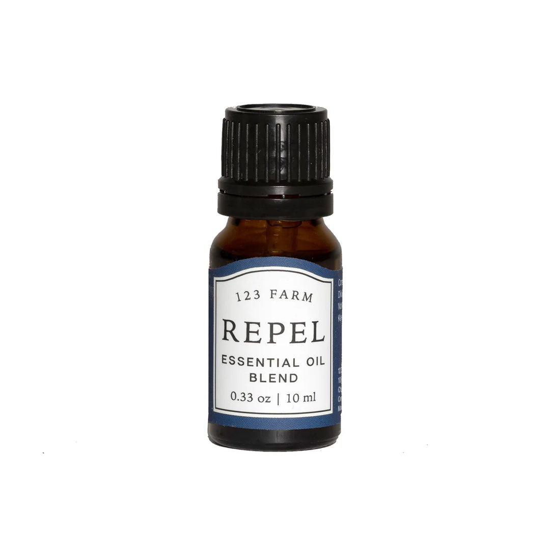 A bottle of 123 Farm Repel Essential Oil Blend with a label indicating it is a 0.33 oz. container. Available at Luca Essentials in Los Angeles.