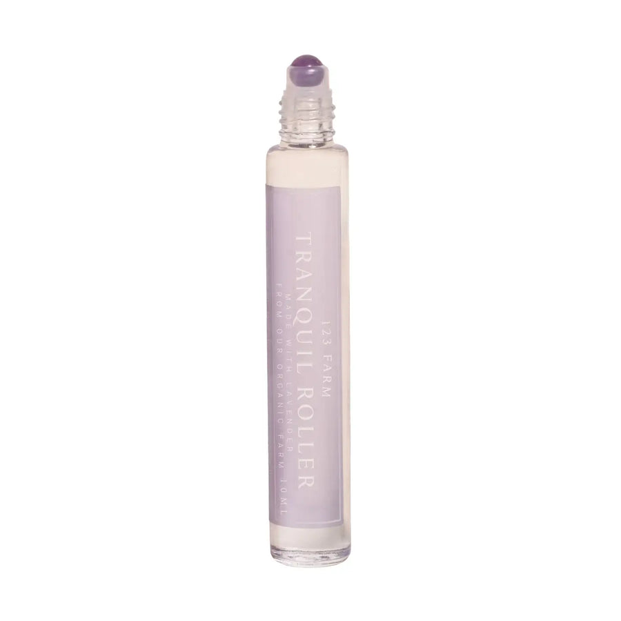 A glass roller bottle of 123 Farm Lavender Tranquil Roller is on a white background. 123 Farm is available at Luca Essentials in Los Angeles.