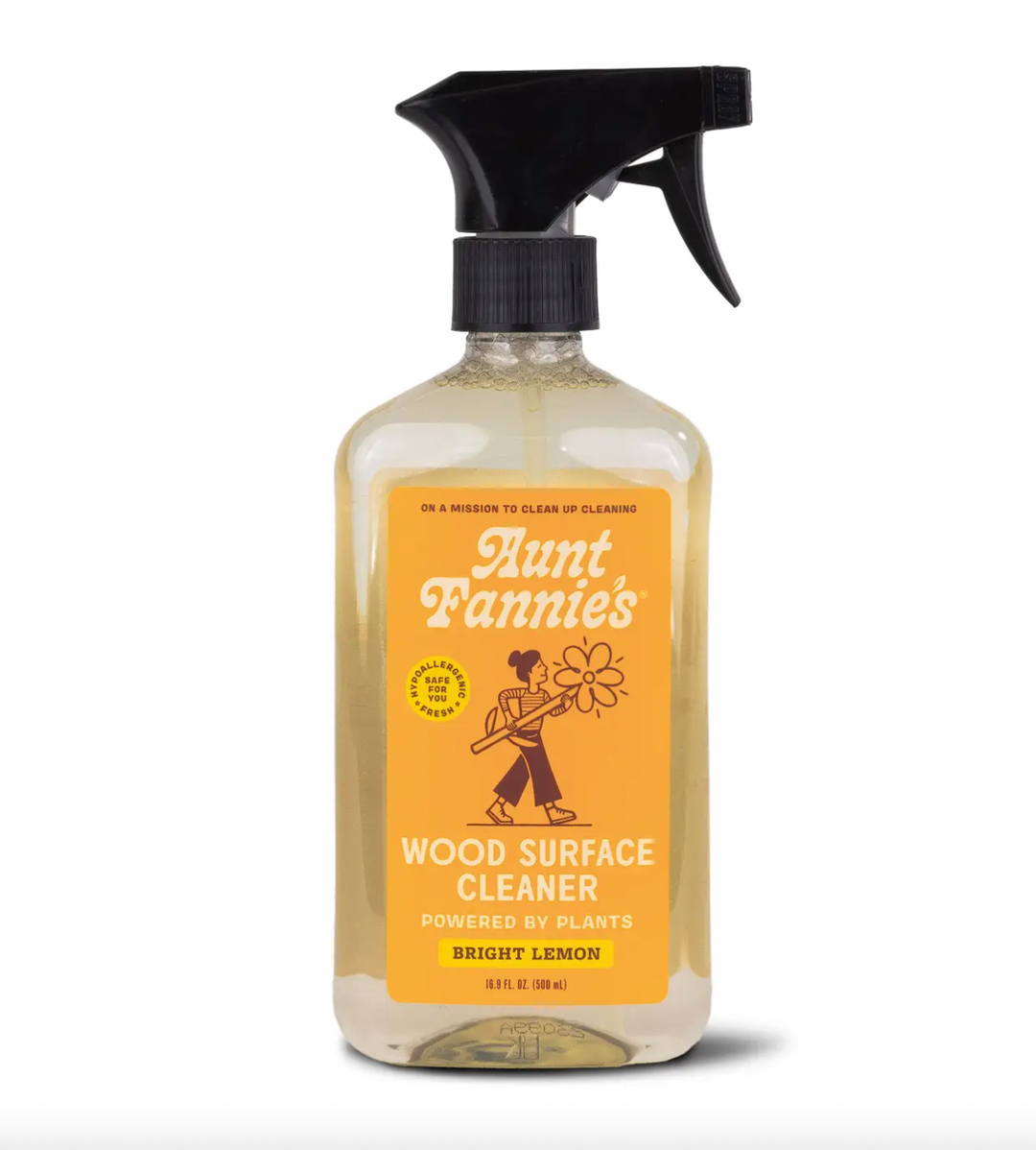 A spray bottle of Aunt Fannies Wood Surface Cleaner with a yellow label, predominantly white background. Aunt Fannie's natural, no-wax formula works wonders on wood tables, walls, counters, and shelves. Available at Luca Essentials in Los Angeles.