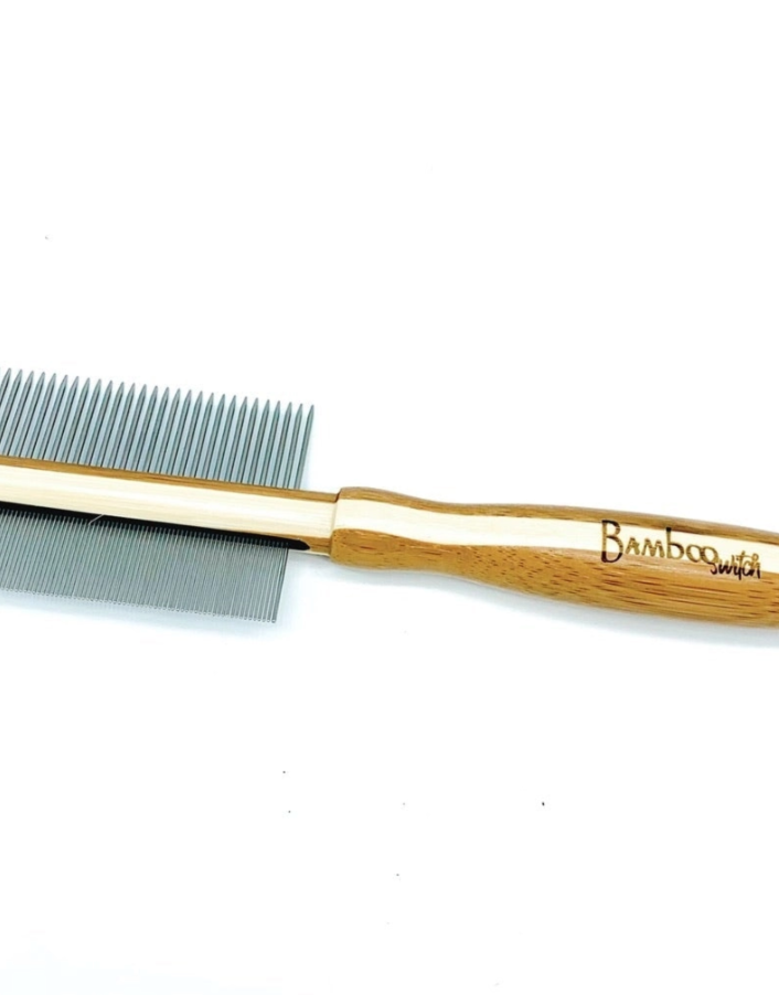 A double sided flea comb with a bamboo handle and metal pegs designed for grooming pets. Bamboo Switch is available at Luca Essentilas in Los Angeles.