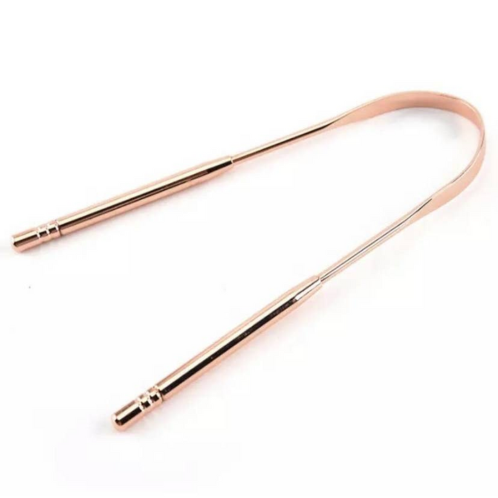A U-shaped rose gold tongue scraper. Bamboo Switch is available at Luca Essentials in Los Angeles.