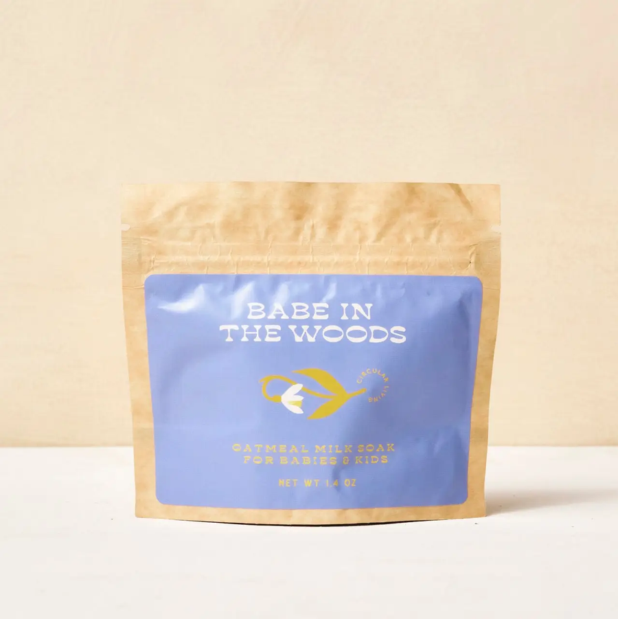 Babe in the Woods bath soak product packaging with a blue sticker on a beige background. Available at Luca Essentials in Los Angeles. 