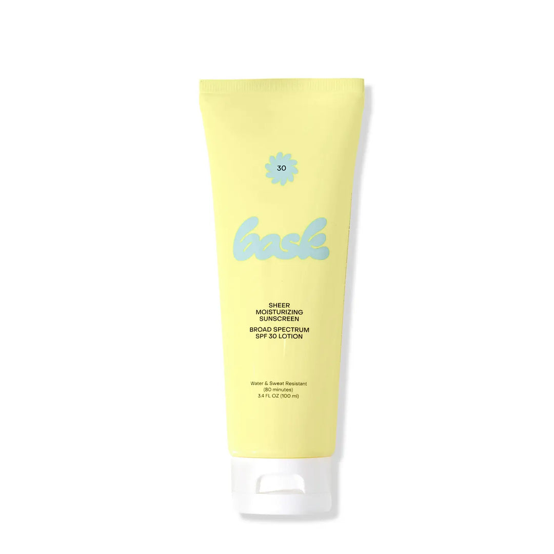 Yellow tube of SPF 30 Sheer Moisturizing Sunscreen with blue text on a white background. Bask is available at Luca Essentials in Los Angeles.