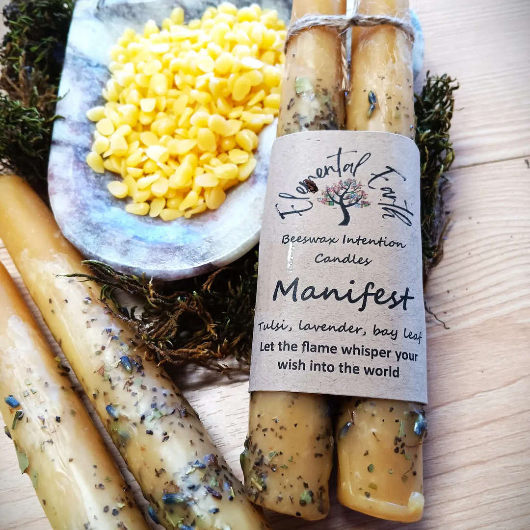 Beeswax intention candles with a label on a wooden surface

100% pure beeswax taper candles dressed with beeswax and natural herbs. Beeswax burns clean and bright. With no added dyes or fragrances, its natural honeyed scent adds a subtle, uplifting layer to any ritual space

Available at Luca Essentials in Los Angeles. 