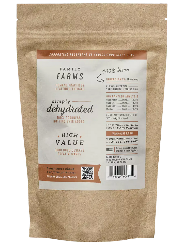 Kraft paper bag with a label for Family Farms dehydrated dog treats on a white background. Available at Luca Essentials in Los Angeles. 