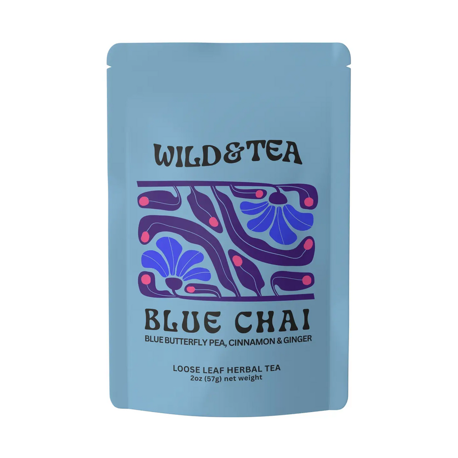 A light blue stand-up pouch of Wild & Tea Blue Chai loose leaf herbal tea, featuring a purple and blue floral pattern on the front. Available at Luca Essentials in Los Angeles. 