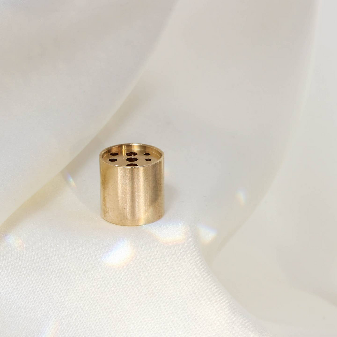 A gold-colored brass incense holder with multiple holes on its top surface, placed on a white fabric background.

Maison Matine perfumes each have their own refreshing scent. The unisex, fresh, unique fragrances are created by eclectic, talented, creative perfumers.

Available at Luca Essentials in Los Angeles. 