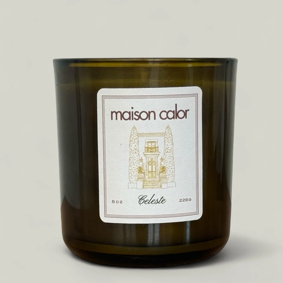 Maison Calor candle with a label on a light gray background. Available at Luca Essentials in Los Angeles. 