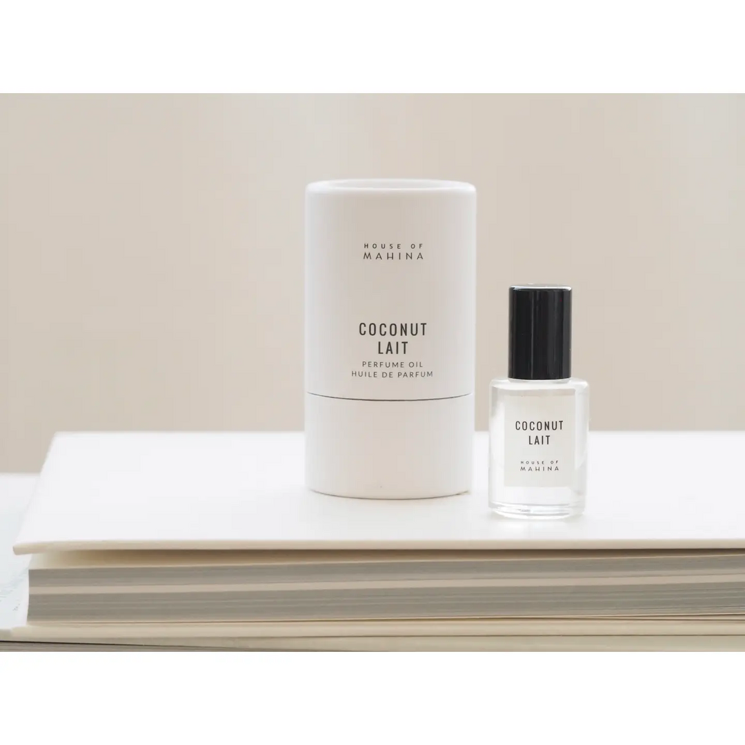 Two perfume bottles labeled 'Coconut Lait' by House of Mahina on a white surface with a beige background.

Hand-blended in micro batches, our perfume oil is composed of organic fractionated coconut oil and our blend of premium phthalate-free fragrance/essential oils.

Available at Luca Essentials in Los Angeles.