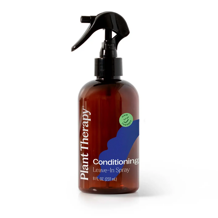 A glass amber bottle of Plant Therapy Conditioning Leave-In Spray in an 8 fl. oz with a pump action spray handle on a white background. Available at Luca Essentials in Los Angles. 