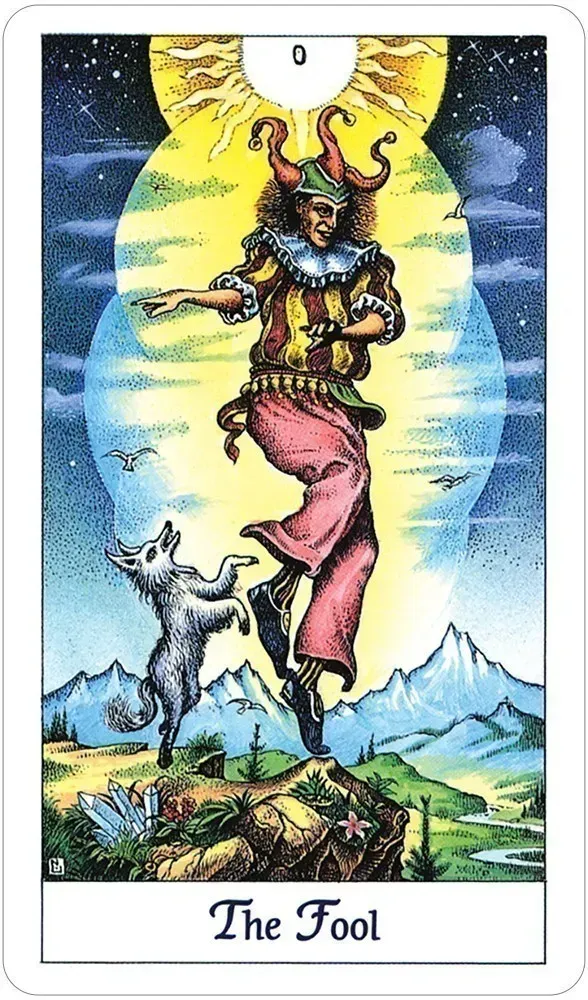 Tarot card titled 'The Fool' featuring a jester-like figure and goat against a mountainous landscape. Available at Luca Essentials in Los Angeles. 