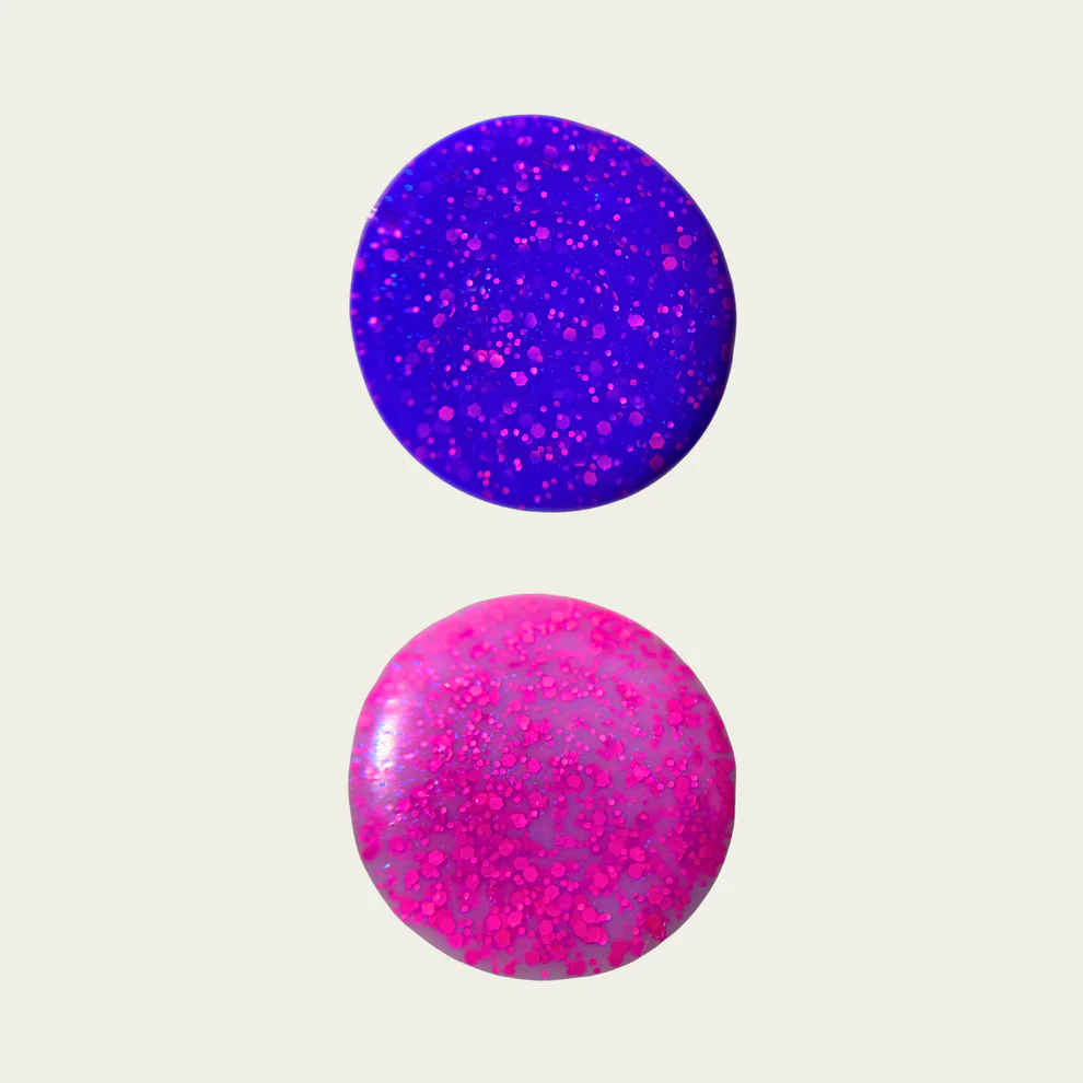 Two purple and pink speckled swatches on a light gray background Available at Luca Essentials in Los Angeles. 