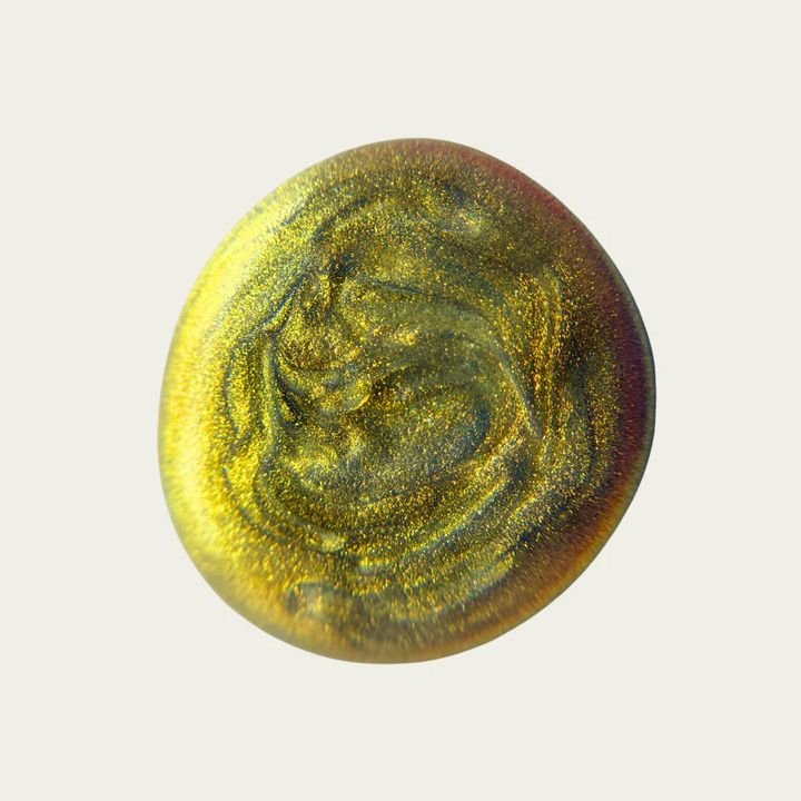 Round swatch of metallic grey and yellow with a textured surface on a light gray background

Sun yellow-gold metallic shimmer with blueish tint. Ethereal, reflective and foil-like.

Available at Luca Essentials in Los Angeles. 
