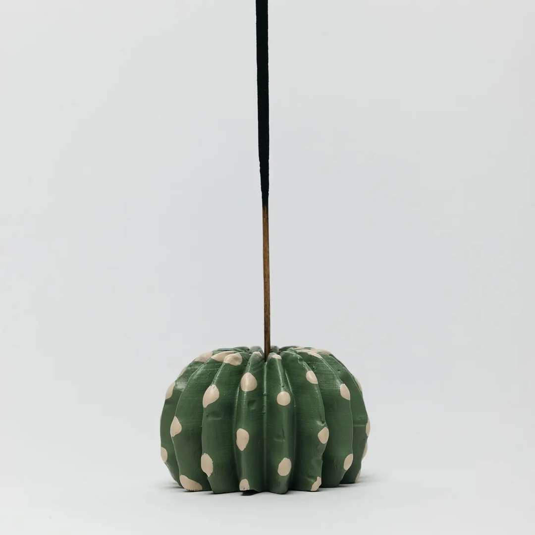 Decorative cactus-shaped ornament with polka dot pattern on a white background. Available at Luca Essentials in Los Angeles. 