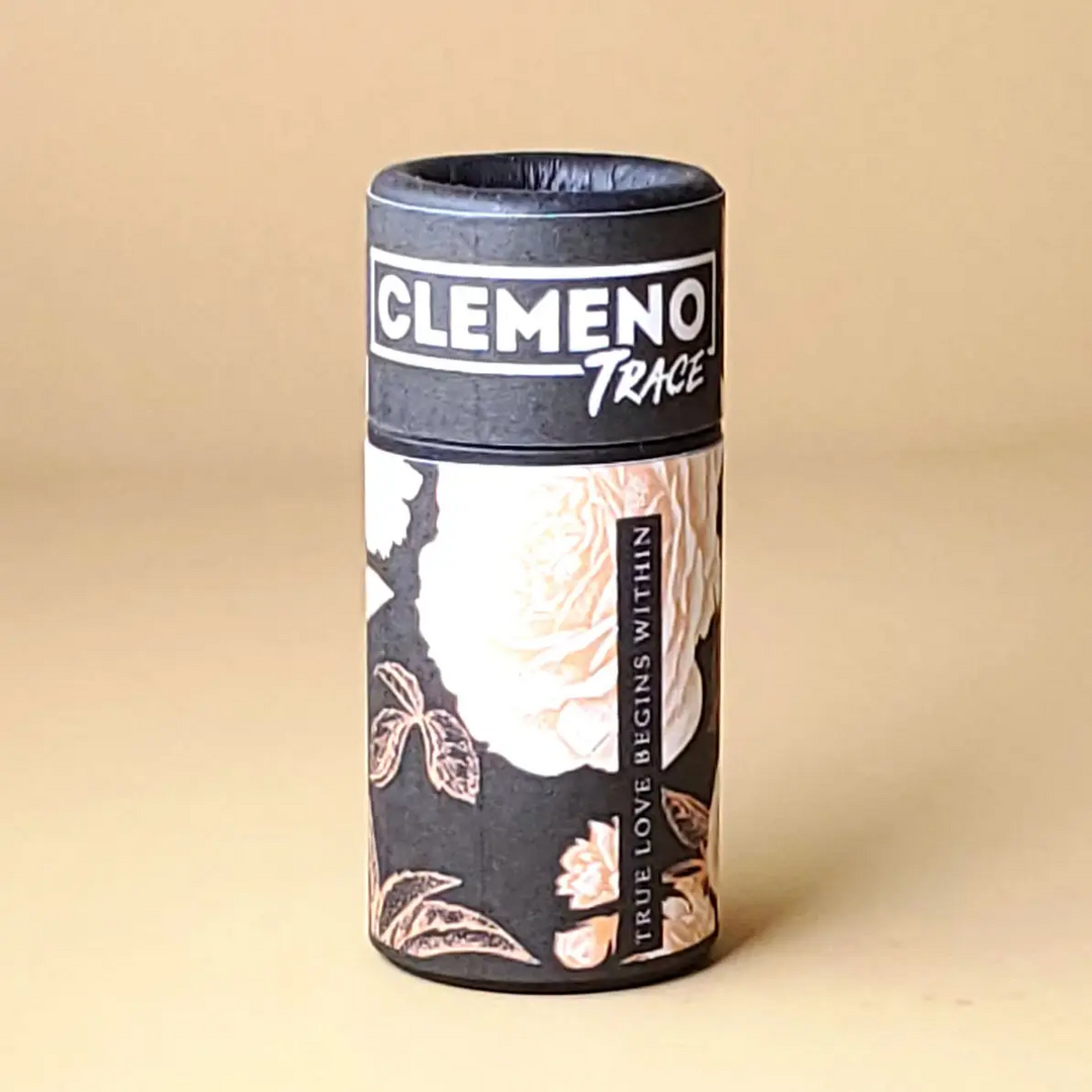 black paper tube with white roses and brand name 'clemeno' on a beige background. Available at Luca Essentials in Los Angeles. 