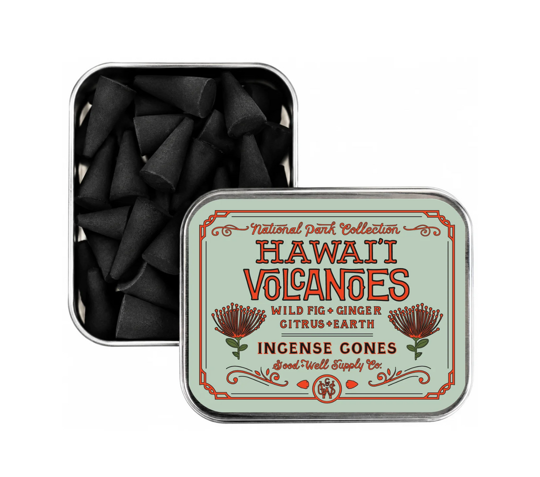 Hawaii Volcanoes label of incense cones in a metal tin with decorative label. Next to a metal til with black charcoal cone shaped incense on a white background. Available at Luca Essentials in Los Angeles. 