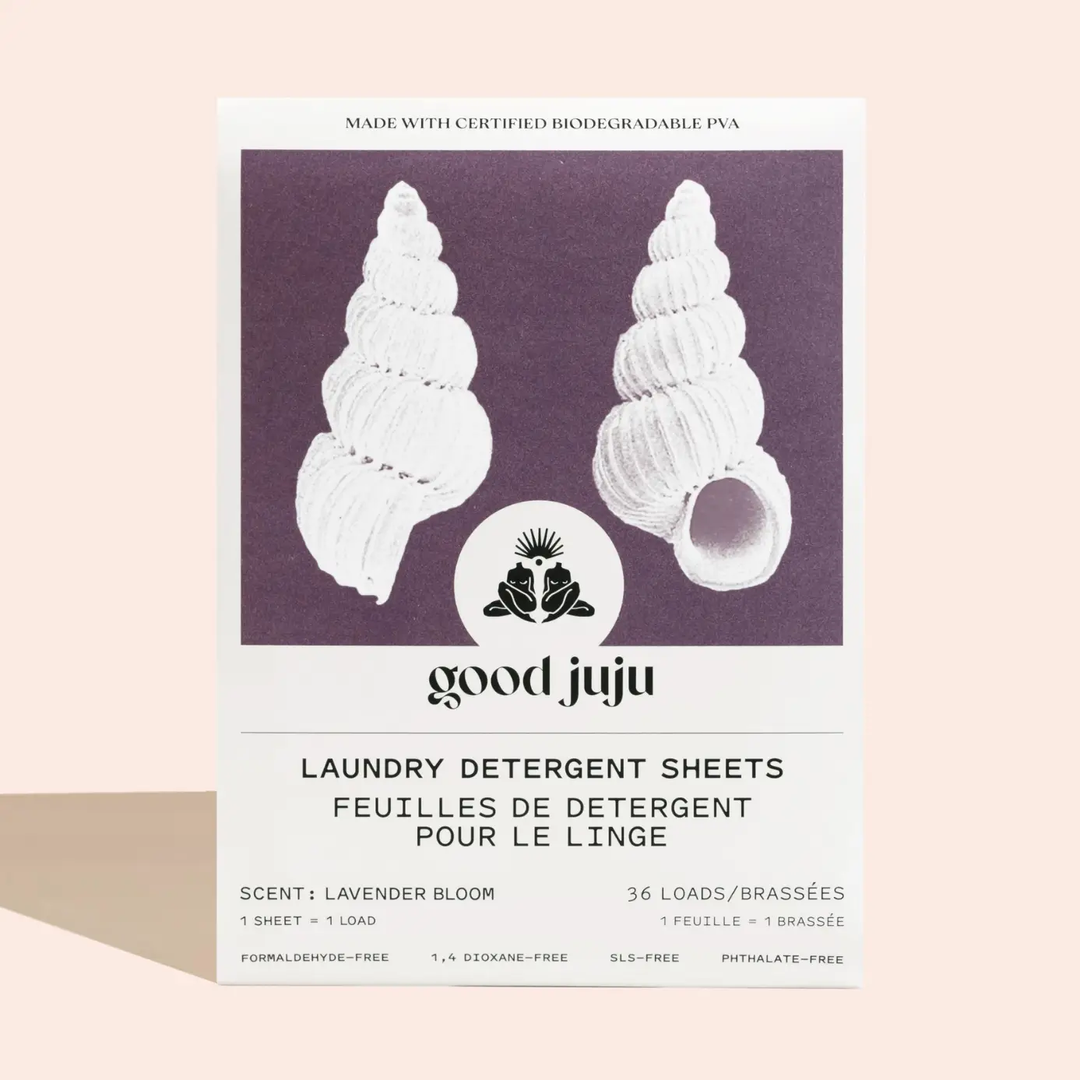 Laundry detergent sheets packaging with shell design, scent 'lavender bloom' and 'good juju' branding. Available at Luca Essentials in Los Angeles. 