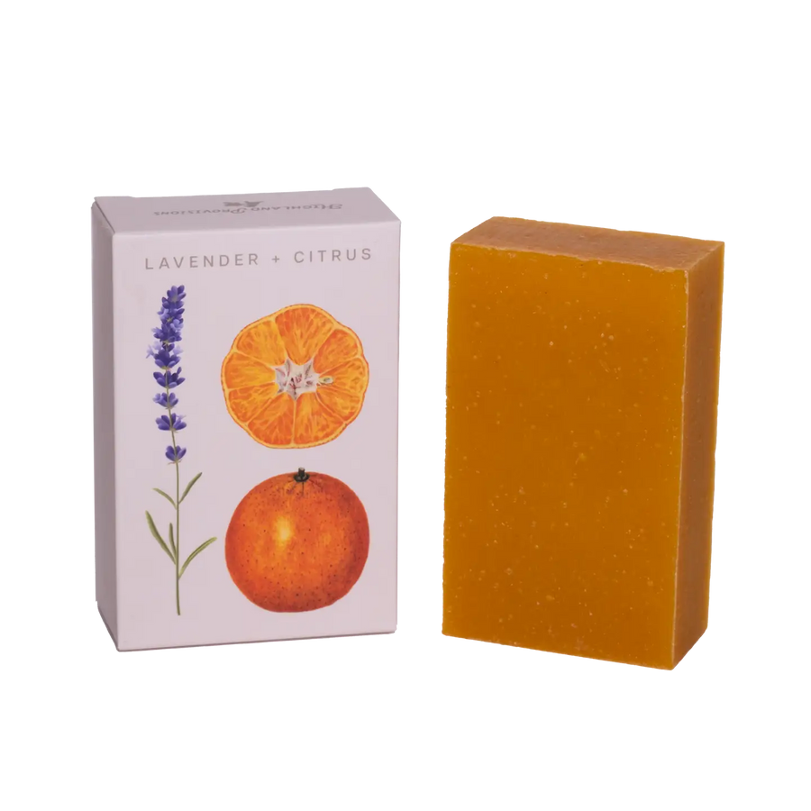 Orange soap bar next to a box with lavender and orange design on a white background. Available at Luca Essentials in Los Angeles. 