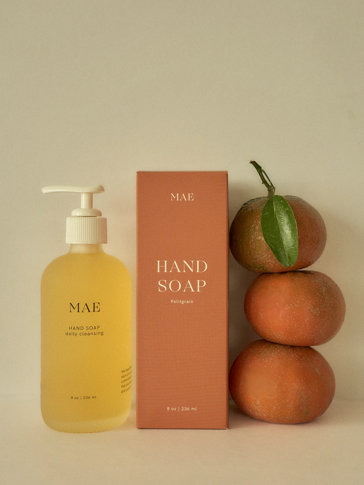Mae hand soap bottle and packaging with oranges on a beige background.

Crafted with organic coconut, olive, and sunflower oils, this silky formula gently cleanses while replenishing the skin’s natural moisture barrier.

Available at Luca Essentials in Los Angeles. 