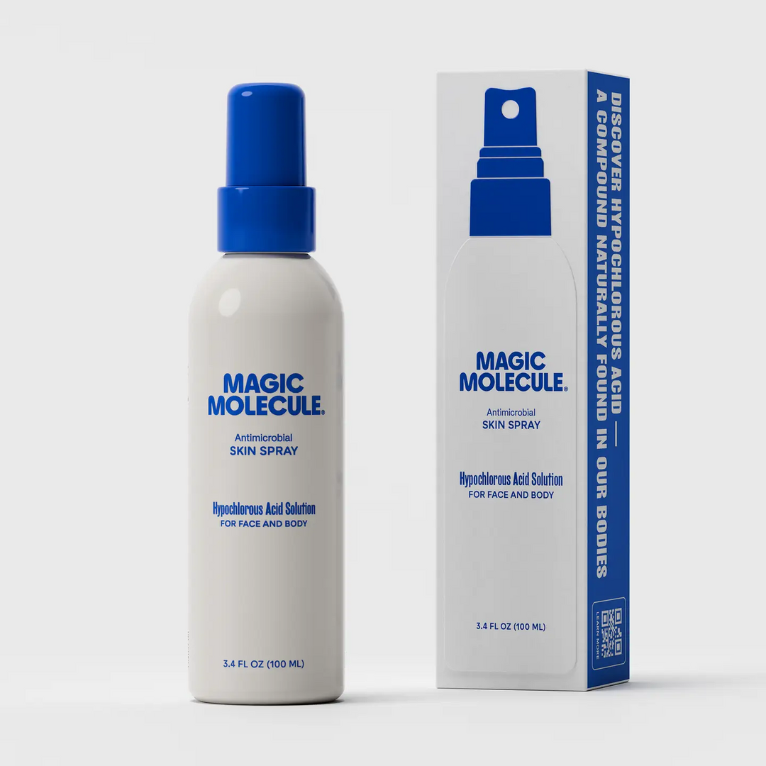 Magic Molecule Antimicrobial Skin Spray bottle with a blue spray top next to its matching blue and white retail box with the size 3.4oz, on a light gray background. Available at Luca Essentials in Los Angeles. 