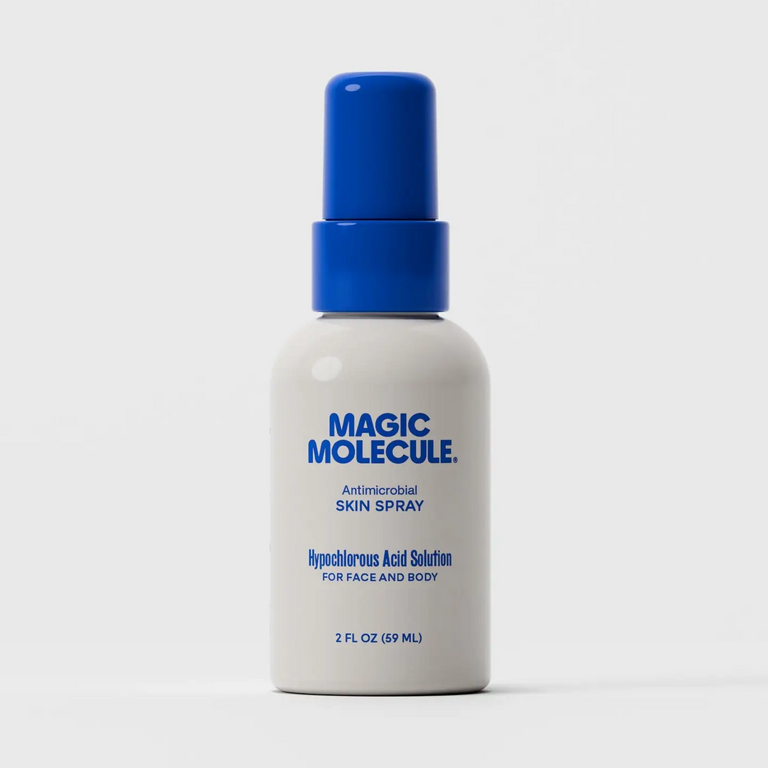 A 2 fl oz white spray bottle of Magic Molecule Antimicrobial Skin Spray with a blue pump dispenser, set against a clean white background. Available at Luca Essentials in Los Angeles. 