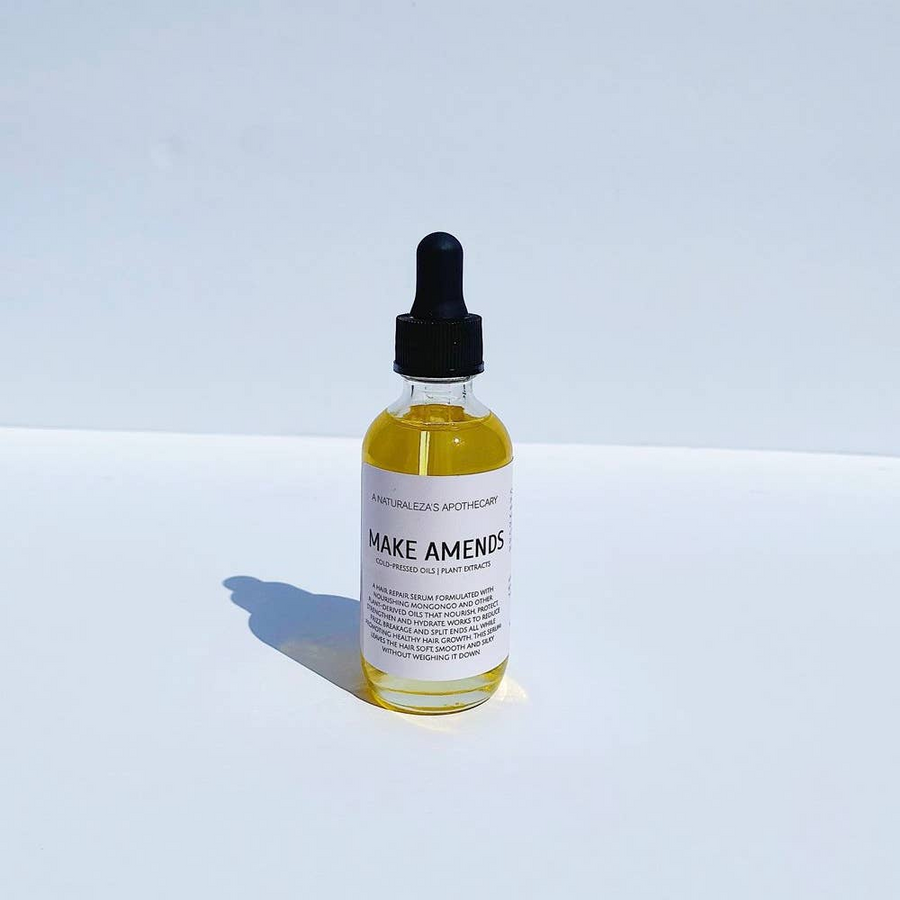 Bottle of golden oil titled 'Make Amends' on a white background. Available at Luca Essentials in Los Angeles. 
