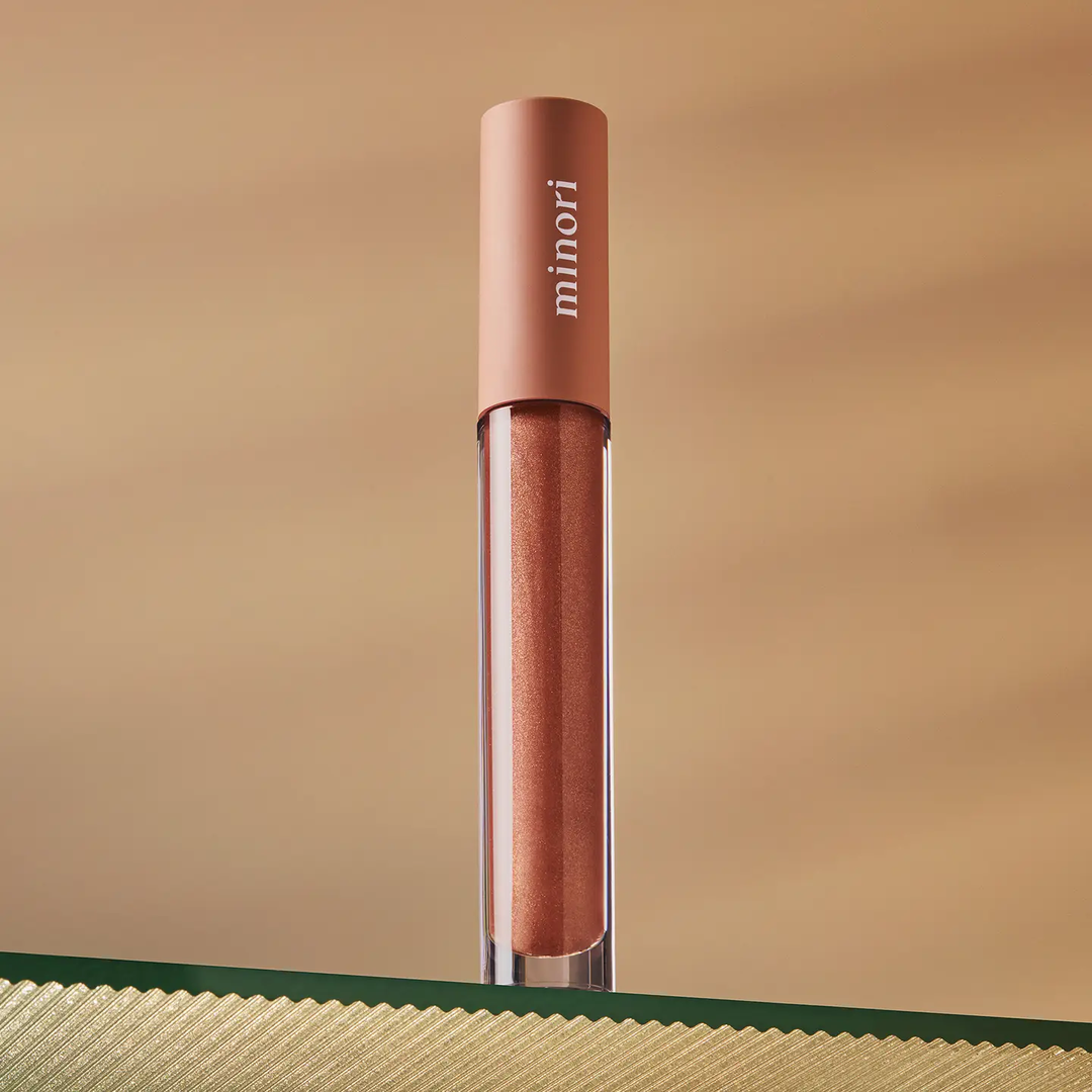 Lip gloss with 'minori' branding on a beige background

A sheer, buttery smooth glossy lip tint that complements your natural lip color and protects your lip's moisture.

Available at Luca Essentials in Los Angeles.