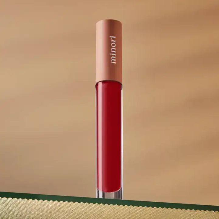Red lipstick with 'minori' branding on a beige background

A sheer, buttery smooth glossy lip tint that complements your natural lip color and protects your lip's moisture.

Available at Luca Essentials in Los Angeles. 