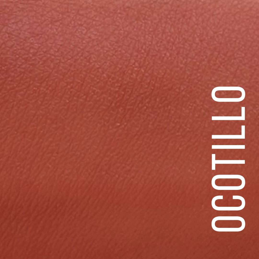 A close-up color swatch of textured leather in a warm reddish-brown-pink tone, with the word 'OCOTILLO' printed vertically in white along the right side. Available at Luca Essentials in Los Angeles. 