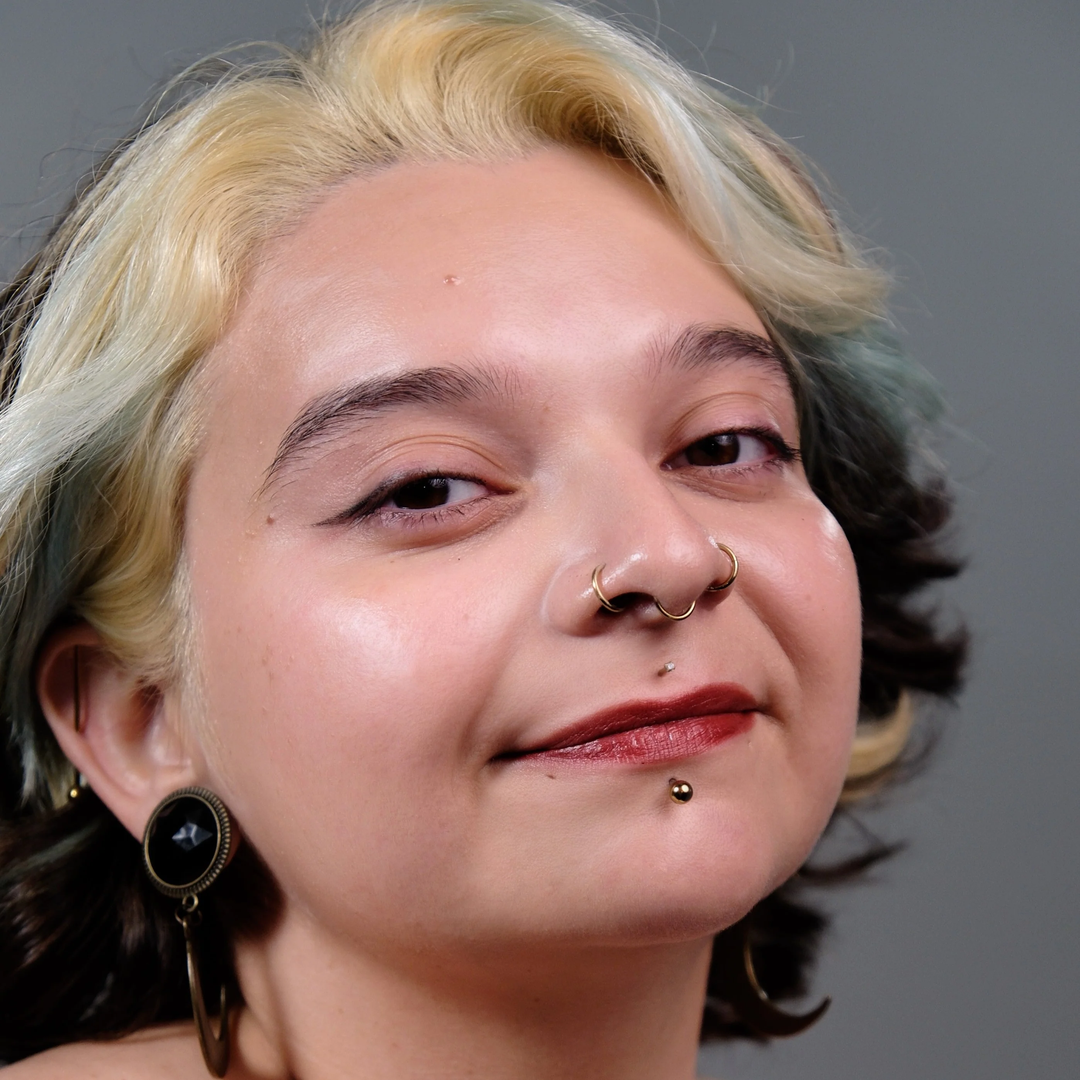Opal- Close-up of a person a light skin tone with styled hair and visible jewelry against a neutral background. Available at Luca Essentials. 