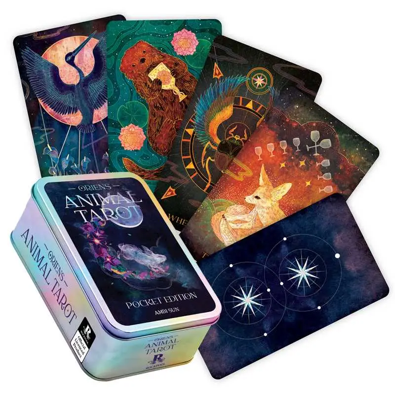 A boxed tarot card set with four illustrated cards fanned out behind it and a metallic tin in front. The packaging and card art feature fantasy animal artwork and celestial motifs in dark teal, black, orange, pink, and iridescent blue tones. Available at Luca Essentials in Los Angeles. 