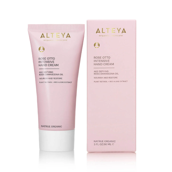 Pink tube of lotion and a pink box of Alteya Rose Otto Intensive Hand Cream with packaging on a white background. Available at Luca Essentials in Los Angeles. 