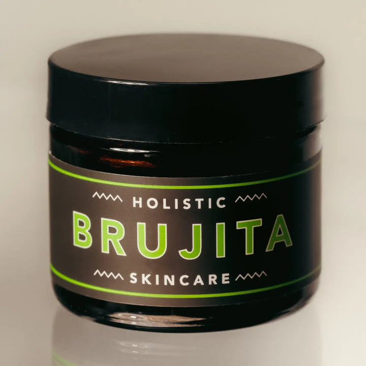 Black Jar of Holistic Brujita Skincare on a neutral background. Available at Luca Essentials in Los Angeles. 