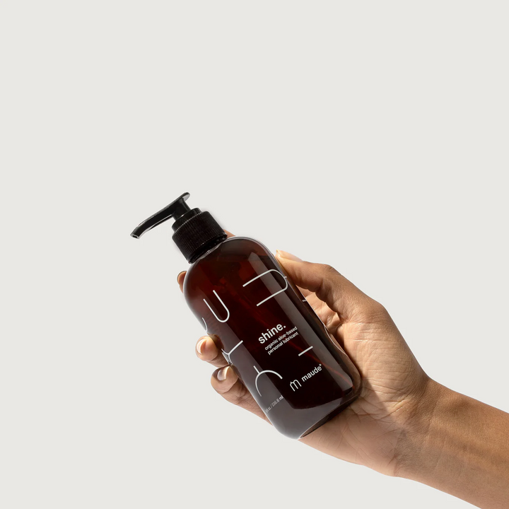 Hand holding a 4oz amber colored bottle of shine aloe based lubricant on a white background.

Formulated with organic aloe and purified water, shine delivers long-lasting glide while supporting the body’s natural moisture. 

Available at Luca Essentials in Los Angeles. 