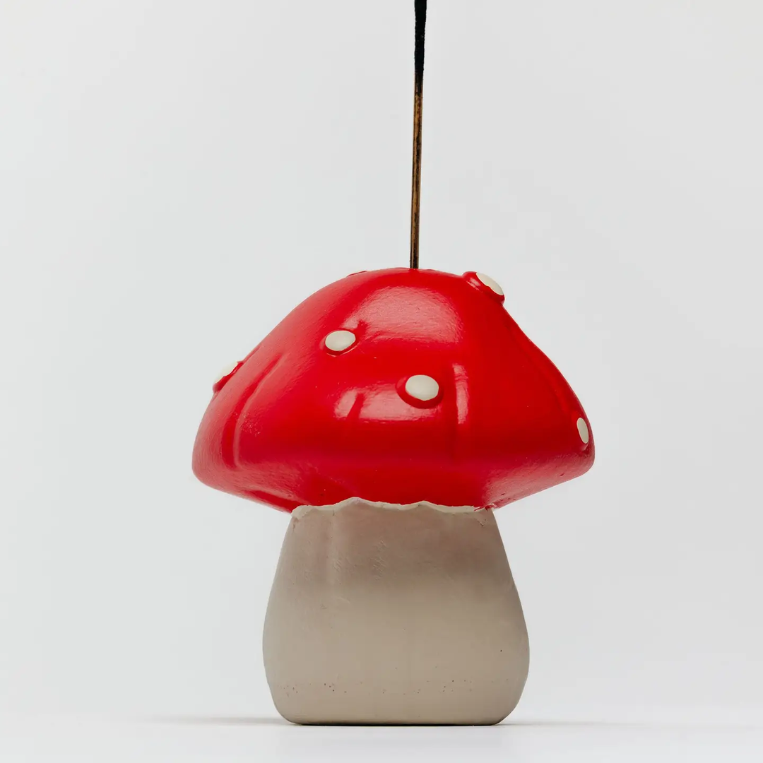 Red mushroom-shaped lamp on a white background. Available at Luca Essentials in Los Angeles. 