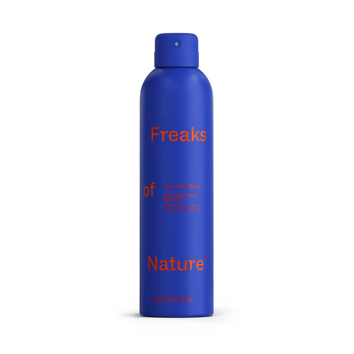 Blue spray bottle with 'Freaks of Nature' text on a white background. Available at Luca Essentials in Los Angeles. 