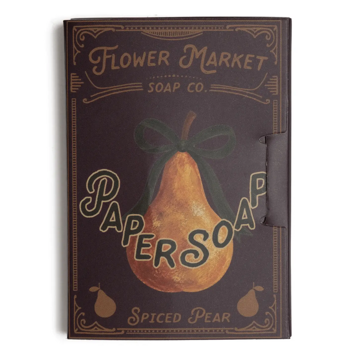 A rectangular boxed soap product labeled 'Flower Market Soap Co.' with a vintage-style pear illustration and the text 'Papersoap' and 'Spiced Pear. Available at Luca Essentials in Los Angeles. 