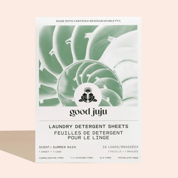 Good Juju laundry detergent sheets packaging in scent 'summer rain' with shell design on a beige background. Available at Luca Essentials in Los Angeles. 