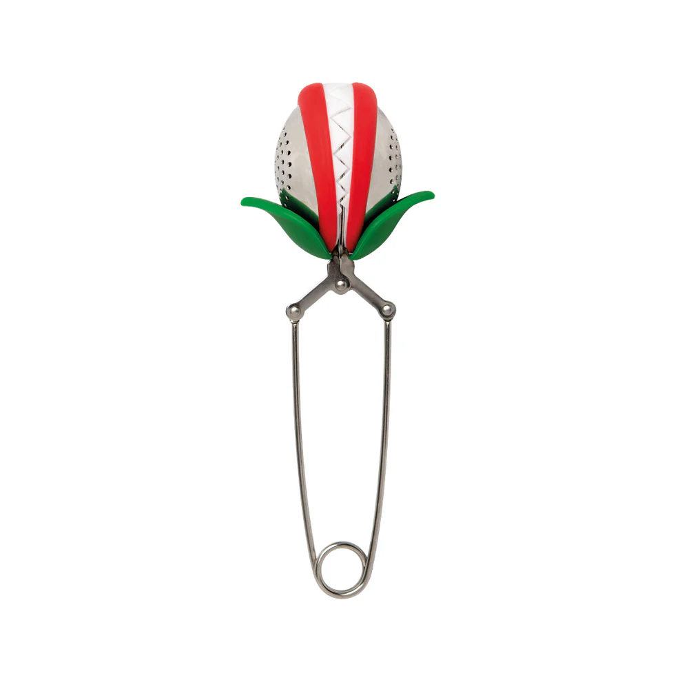 Tea infuser shaped like a venus fly trap with red and white stripes and green leaves on a white background. Available at Luca Essentials in Los Angeles. 