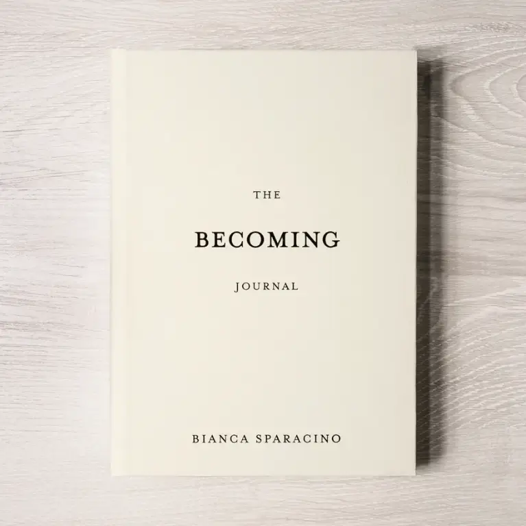 Book titled 'The Becoming Journal' by Bianca Sparacino on a wooden surface. Available at Luca Essentials in Los Angeles. 