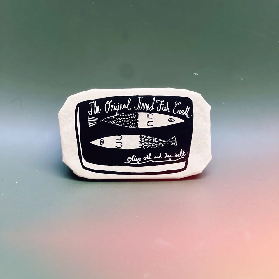 Wrapped up tin with black and white fish illustration and text on a gradient background. Available at Luca Essentials in Los Angeles. 
