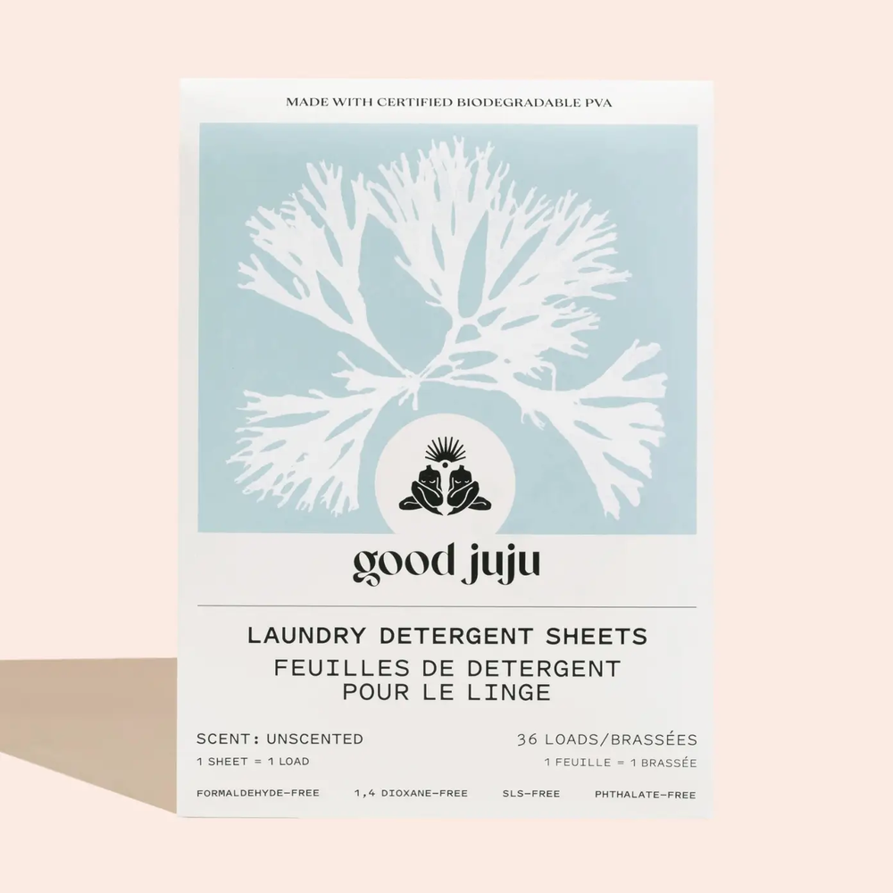 Good Juju laundry detergent sheets packaging, unscented with leaf design on a light blue label on a beige background. Available at Luca Essentials in Los Angeles. 
