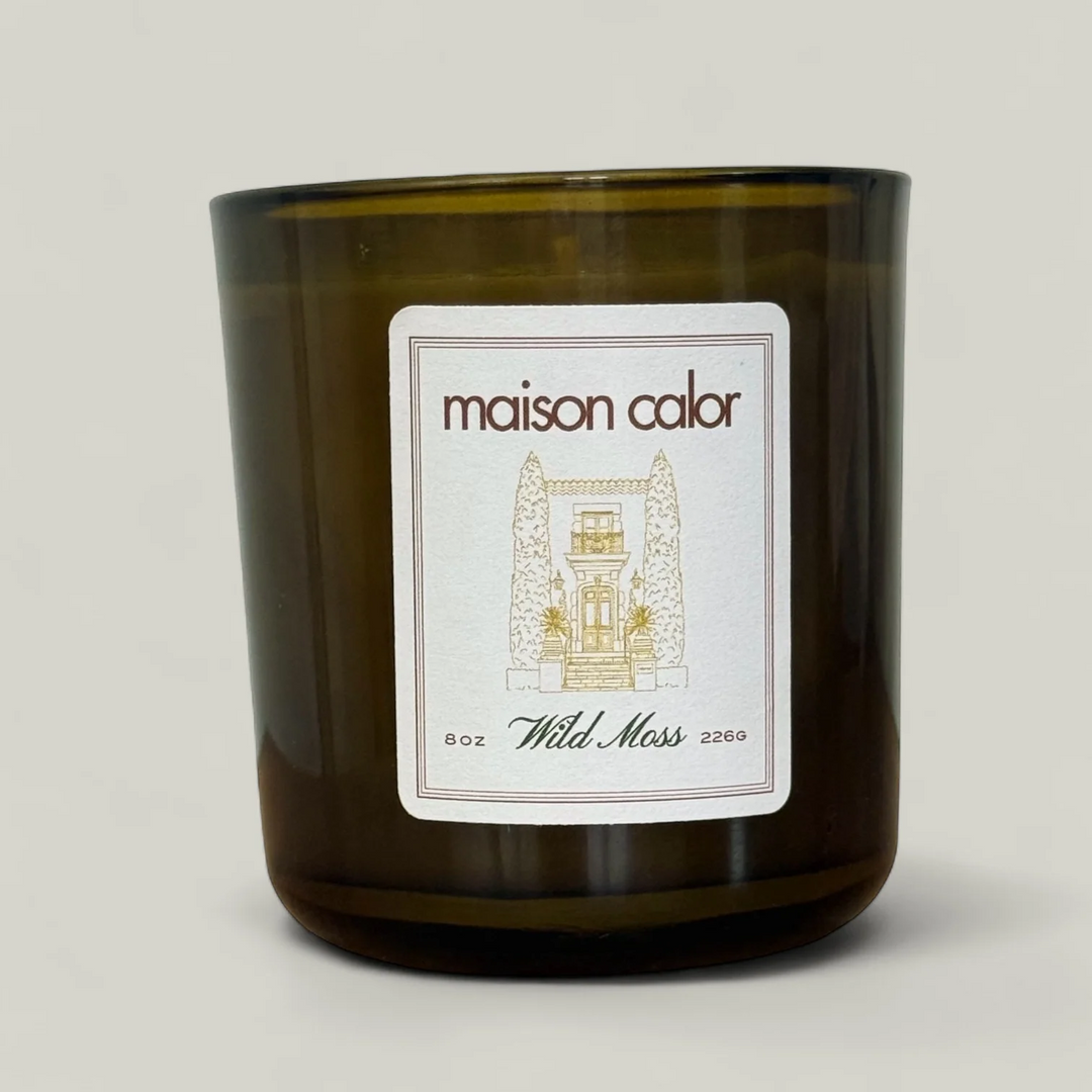 Maison Calor candle with a label on a light gray background. Available at Luca Essentials 