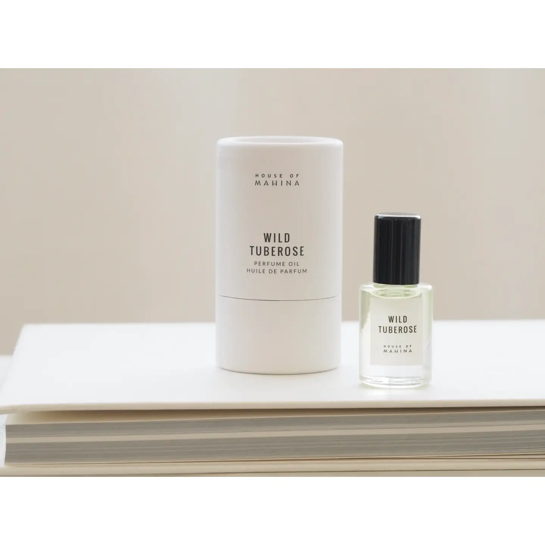 Two perfume bottles labeled 'Wild Tuberose' by House of Mahina on a light surface with a neutral background.

Hand-blended in micro batches, our perfume oil is composed of organic fractionated coconut oil and our blend of premium phthalate-free fragrance/essential oils.

Available at Luca Essentials in Los Angeles. 